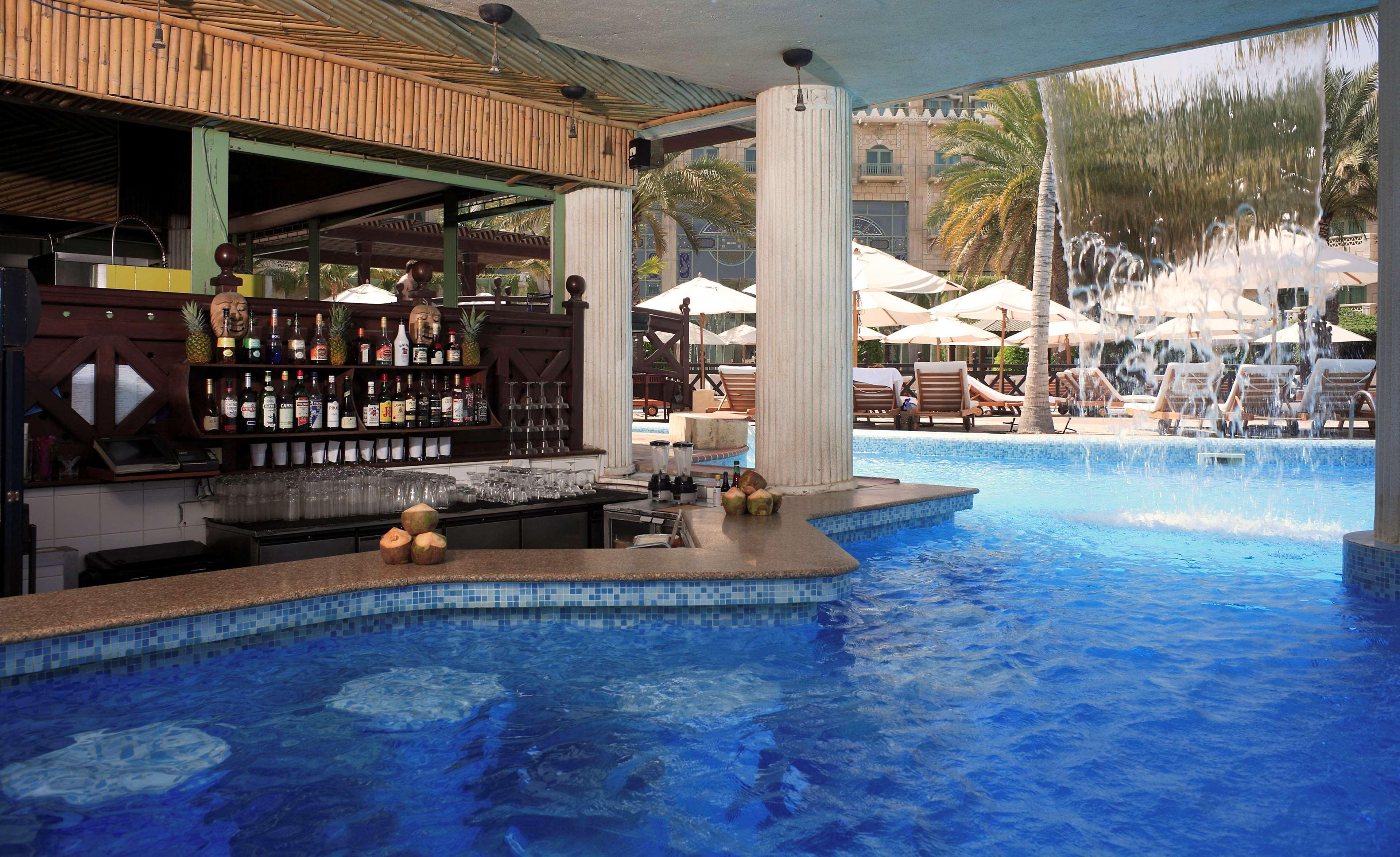 Grand Hyatt Muscat Hotel Facilities photo The pool bar at the Sheraton Jumeirah Hotel